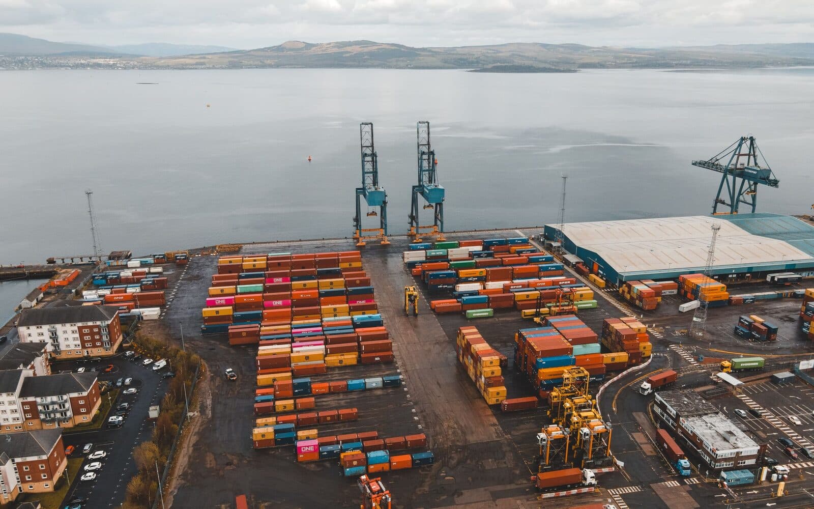 Shipping containers and cranes at a freight port seen from above